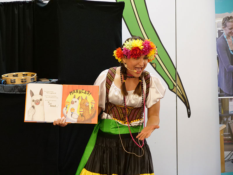 Children's presenter reading a book in costume