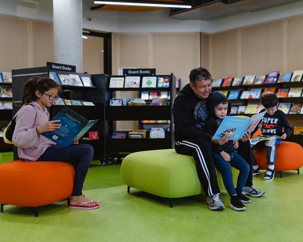 People in Children's area reading books.